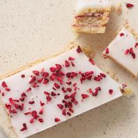 Raspberry Slice · Shortbread cookie with raspberry jam, topped with lemon icing, and freeze-dried raspberry.