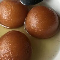 Gulab Jamun · Cheese and milk balls soaked in cardamom simple syrup.
