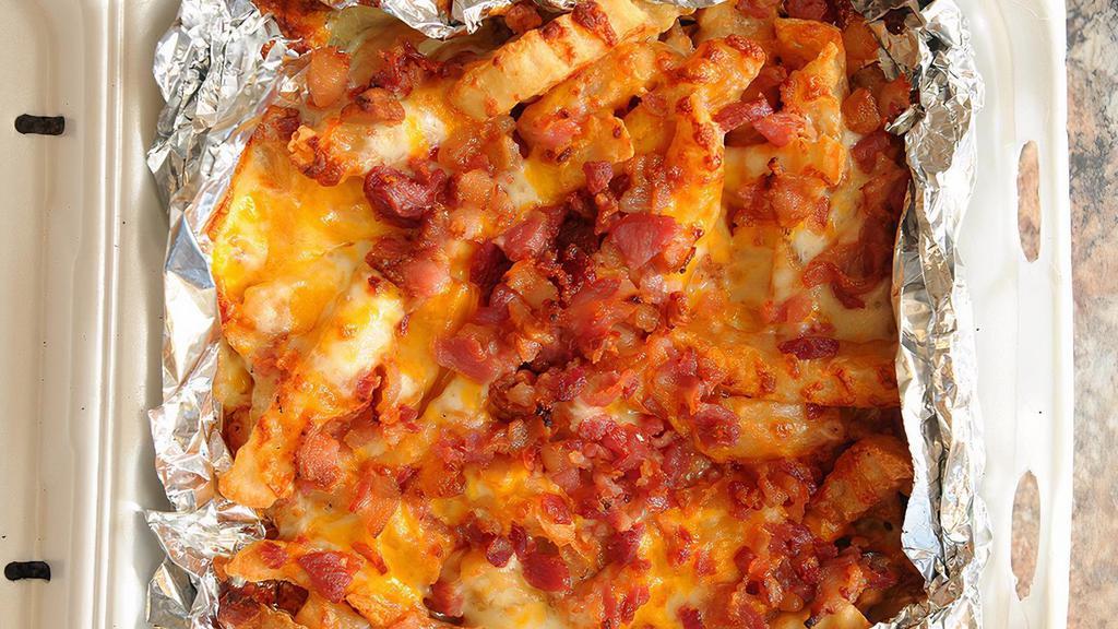 Cheesy Fries · Served with mozzarella, cheddar, bacon and 1 side of any sauce. Extra sauce for an additional charge.