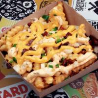 Loaded Fries - Single · Fries, Bastard Original Dressing, Finely Chopped Yellow Onions, Jalapeños, Cheese Sauce and ...