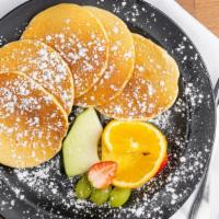 Plain Pancake · Served with a scoop of ice cream, fresh fruit, and syrup. Decorated with powder sugar.
