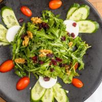 Goat Cheese Salad · Arugula, cherry tomatoes, cucumber, walnut, cranberry tossed with balsamic dressing, and top...