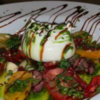 Burrata · Creamy burrata mozzarella, heirloom tomatoes, sun-dried tomatoes, & shredded basil topped wi...