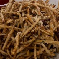 Parmigiana Truffle Fries · Crispy shoestring fries tossed in parmigiana cheese and truffle oil.