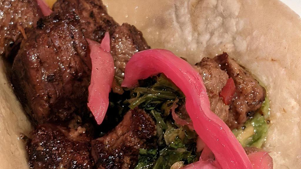 Carne Asada Taco · Grilled steak, chimichurri, pickled onions, guacamole.
