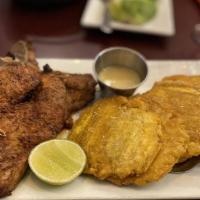 Chuletas · Fried or grilled pork chops with pickled onions. Served with fried plantains.