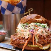 Pulled Pork Sandwich · Pulled pork on a pretzel bun with coleslaw and pickles. Served with fries.