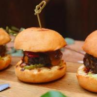 Beef Sliders · 3 sliders with bacon, garlic aioli, tomato, pickles, and cheddar cheese.