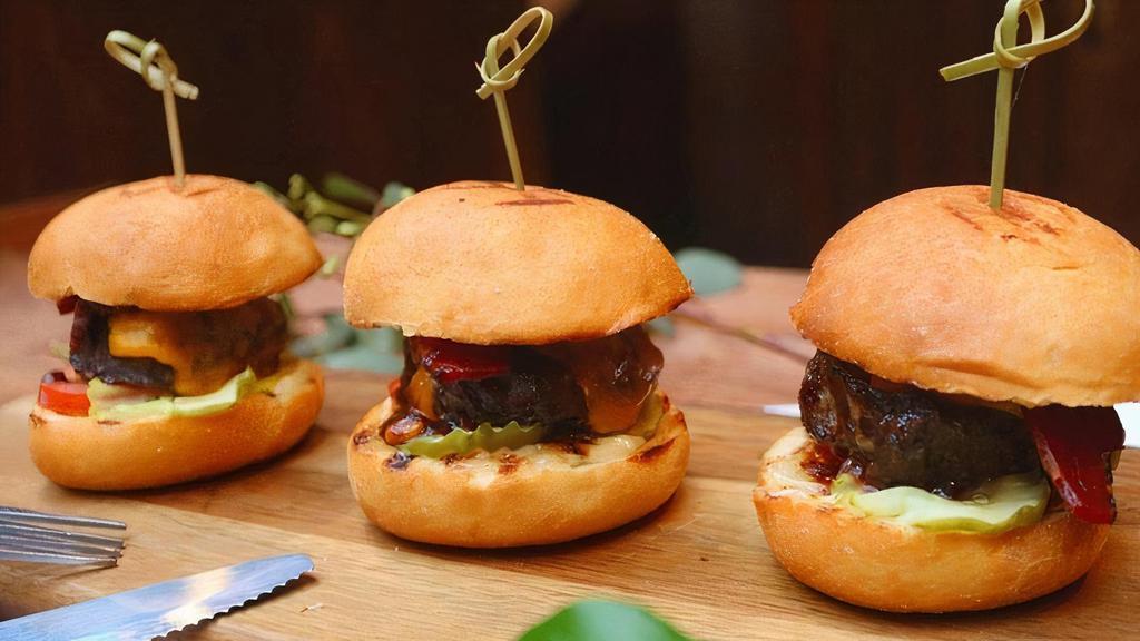 Beef Sliders · 3 sliders with bacon, garlic aioli, tomato, pickles, and cheddar cheese.