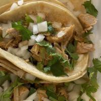 4 Grilled Chicken Tacos · Topped with cilantro and onion, served with spicy green sauce and limes. Corn tortillas.