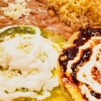 Huevos Rancheros · Eggs, chili-sauce ,sour cream, queso fresco on a semi fried tortilla served with pinto or bl...