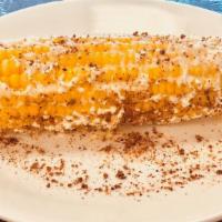 Elotes Callejeros (Corn On The Cob) · Corn on the cob Mexican style with spread mayo, cotija cheese and tajin Chile powder on the ...