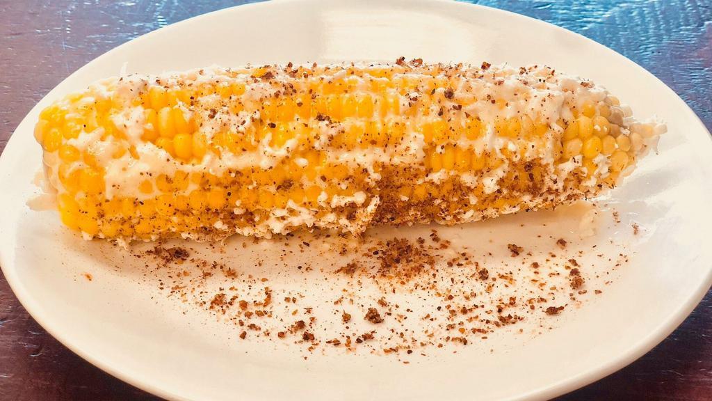 Elotes Callejeros (Corn On The Cob) · Corn on the cob Mexican style with spread mayo, cotija cheese and tajin Chile powder on the side