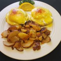 Eggs Benedict · Two poached eggs, Canadian bacon on an english muffin topped with hollandaise sauce.