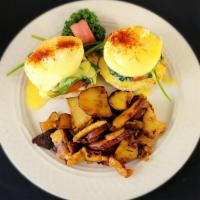 Veggy Benny · Two poached eggs, tomato slice and spinach on an english muffin with hollandaise sauce. Serv...