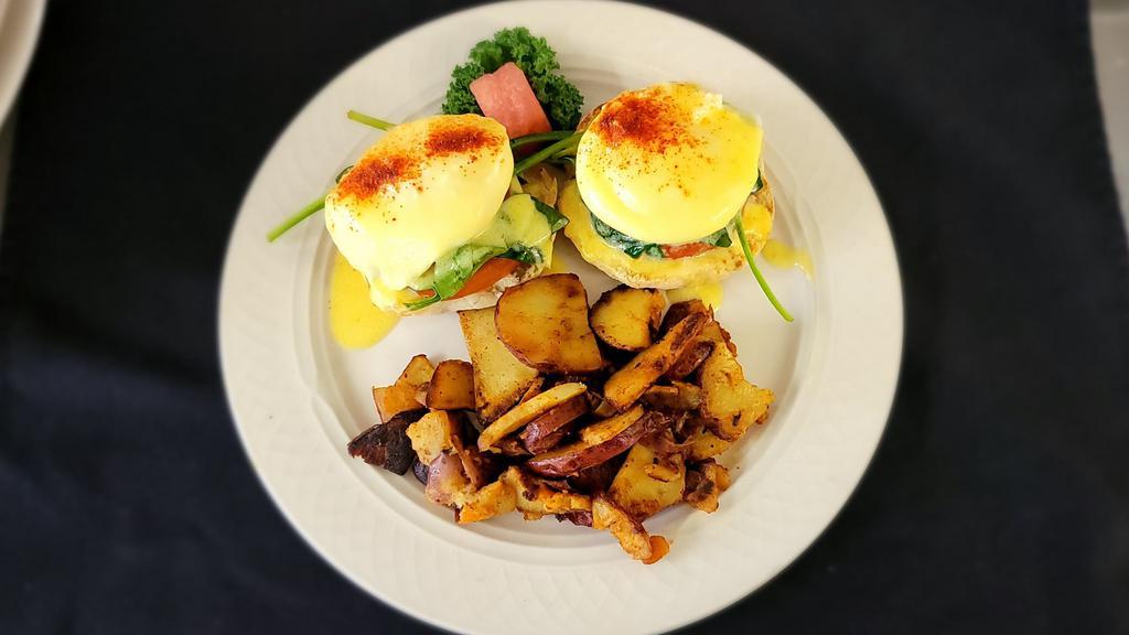 Veggy Benny · Two poached eggs, tomato slice and spinach on an english muffin with hollandaise sauce. Served with choice of a side.