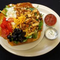 Taco Salad · Beef or chicken over crisp lettuce, tomatoes, onions, black olives, cheese with salsa and so...