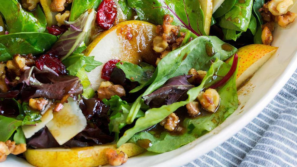 Pear Salad · Romaine lettuce, arugula, pears, tomatoes, gorgonzola, and candied walnuts with house dressing.
