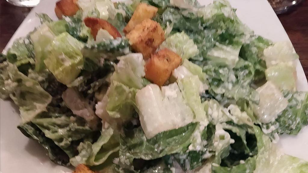 Classic Caesar Salad · Romaine hearts tossed with our famous homemade caesar dressing with croutons and romano cheese.
