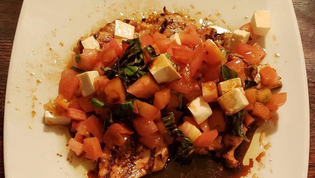 Grilled Chicken Caprese · Gluten free. Breast of chicken topped with diced fresh tomatoes, mozzarella, olive oil and basil with a balsamic glaze.
