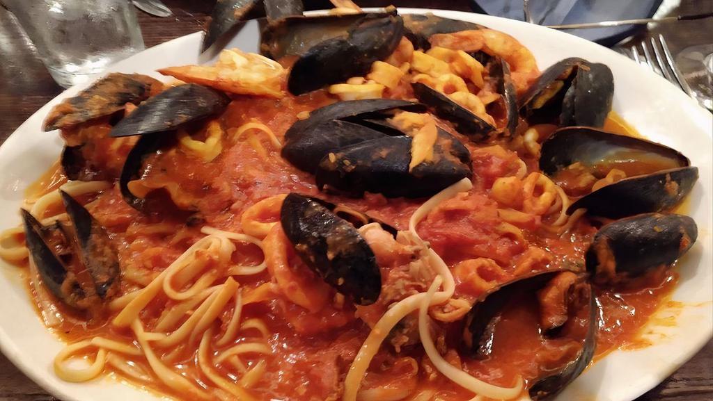 Seafood Fra Diablo · Shrimp, mussels, calamari and chopped clams in a spicy tomato sauce nested on a bed of linguini.