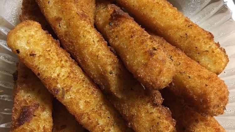 Zucchini Sticks  · Zucchini sticks dipped in an egg mixture with bread crumbs, parmesan cheese, baking powder, and salt, fried until golden brown.