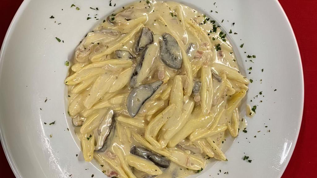 Cortecce Alla Puglia · Homemade pasta tossed with pancetta, shitake mushrooms and truffle cream sauce