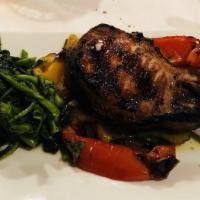 Berkshire Kurobuta Pork Chop · 20 oz. topped with sweet and hot cherry peppers, onions, served with broccoli rabe.