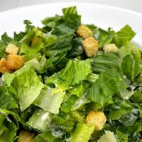Caesar Salad · Romaine lettuce tossed in caesar dressing with parmesan cheese and crispy mofongo croutons.