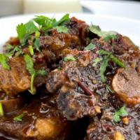 Oxtail · Caribbean braised oxtail served with white rice, black beans and sweet plantains