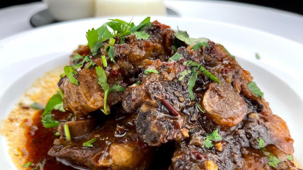 Oxtail · Caribbean braised oxtail served with white rice, black beans and sweet plantains