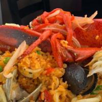 Seafood Paella · Lobster, Shrimp, Calamari, Black Mussels, Clams and Saffron Rice.