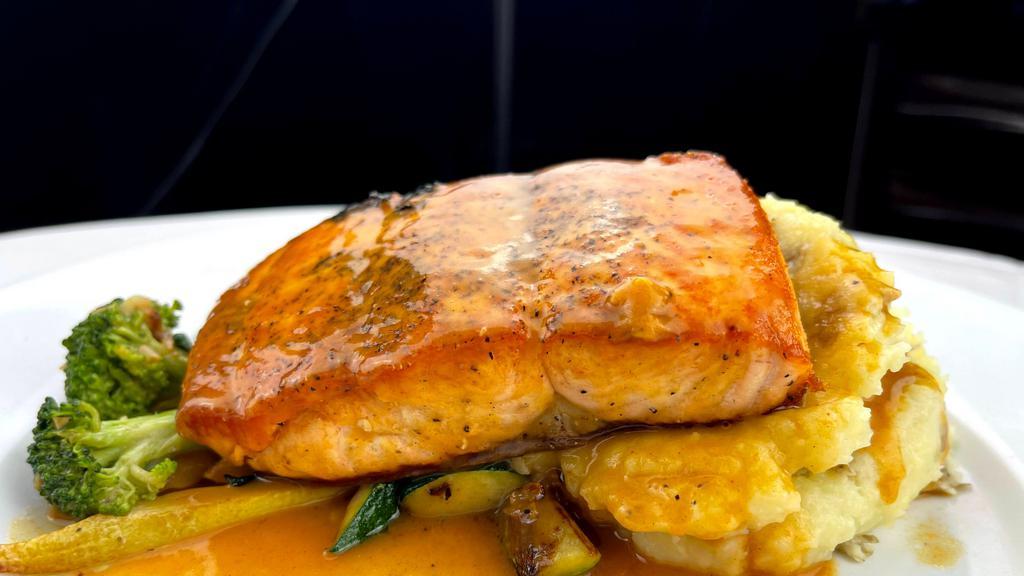 Salmon · Seared salmon served with mashed potatoes and mixed vegetables, topical lobster sauce.
