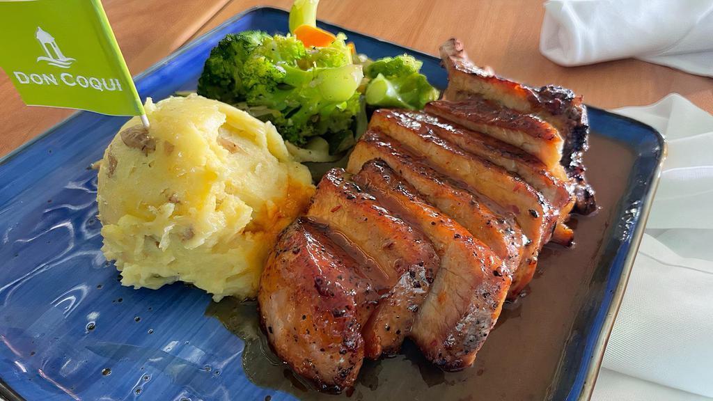 Pork Chop · Grilled Spice Rubbed Pork Chops served with Mashed Potatoes and Sauteed Vegetables with Garlic Mojo