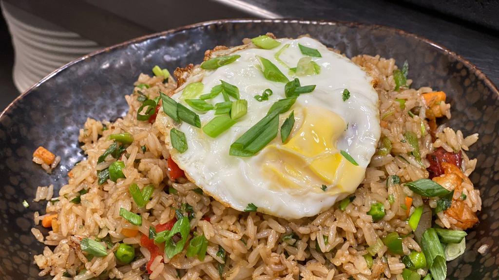Fried Rice · Shrimp, chicken, pork, seasonal vegetables, sweet plantain topped with a fried egg.