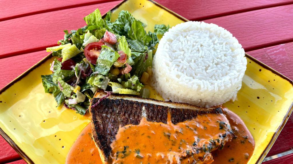 Red Snapper · Crispy whole red snapper served with coconut rice, tostones and curtido salad.