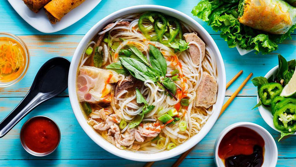 House Pho Noodle Soup 经典火车头 · Comes with Rare Eye Roud, Brisket, Tripe and Tendon, with rice noodles, served with beef broth, onions, scallions, and lemon, basil & bean sprouts on the side.