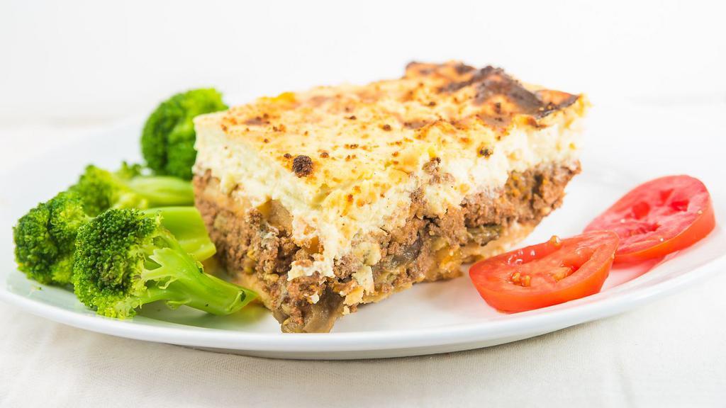 Moussaka · Layers of eggplant, roasted potatoes, and chopped meat.  Seasoned with nutmeg.  
 Topped with bechamel sauce and baked until golden brown. Served with rice and vegetables.
Choice of greek salad or homemade soup.