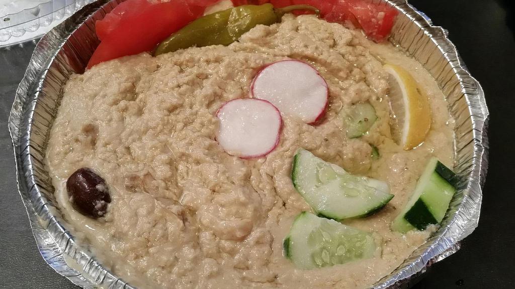 Hummus · Mashed chickpea with veggies and tahini sauce. Served with pita