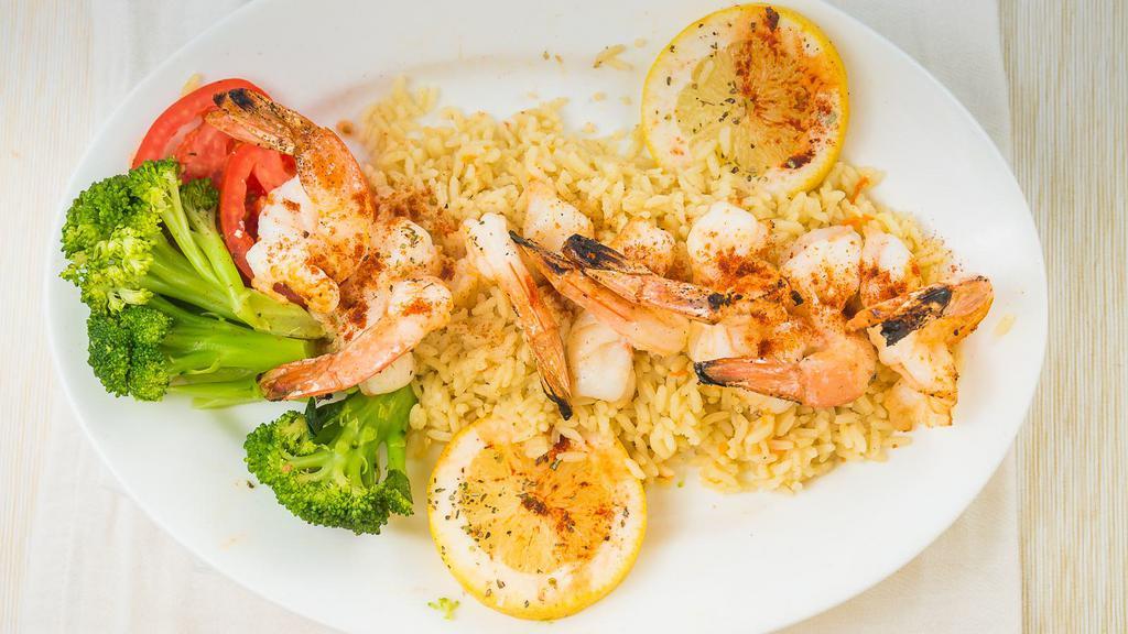 Shrimp Santorini · Broiled and topped with grilled tomatoes, feta cheese and creamy garlic lemon sauce.