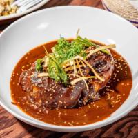 Mole Poblano · Contains nuts. Half chicken in our homemade mole sauce, served with wild and brown rice, ref...