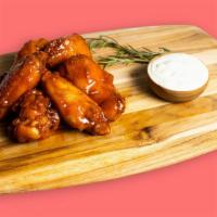 Garlic-Ing Wings · Our famous wings fried until perfectly golden and tossed in house made garlic sauce. Served ...