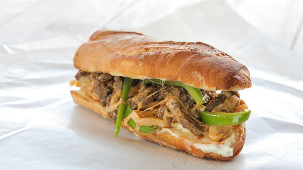 Philly Cheesesteak Sandwich · Ultimate classic philly cheesesteak with fresh lettuce, diced red tomatoes, grilled onions, grilled green peppers, mayonnaise all topped with fresh melted swiss cheese.