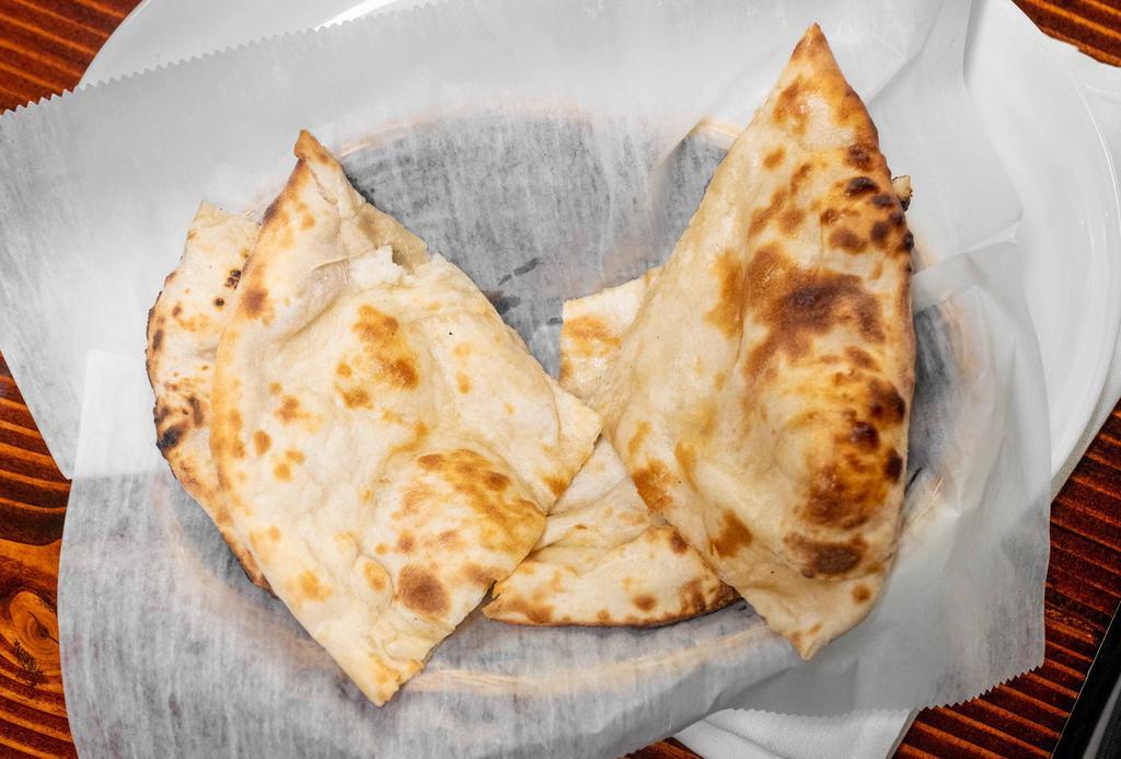 Plain Naan · A leavened flat bread made with flour is baked fresh in tandoori oven.