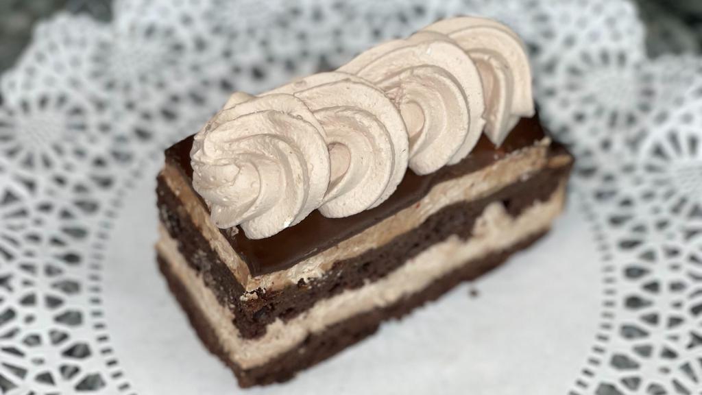 Chocolate Mousse Slice · Chocolate cake layered with chocolate mousse and topped with chocolate ganache.