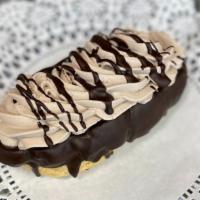 Chocolate Mousse Eclair · Puffed dough with fresh wiped cream, top drizzled in chocolate.