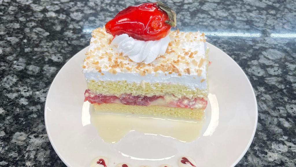 Tres Leches Slice · 3 milks sponge cake with strawberry filling and topped with whipped cream.