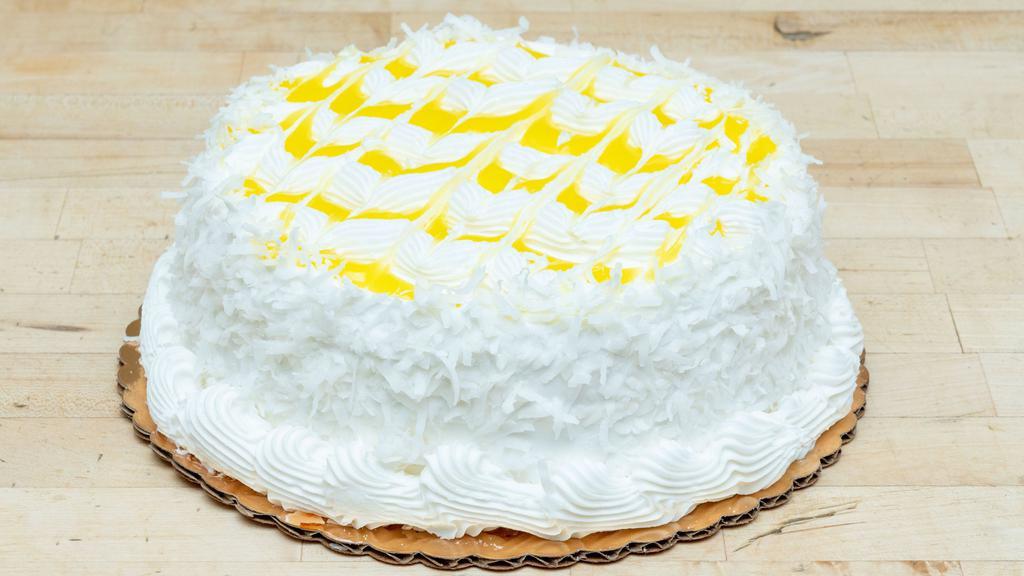Lemon Coconut Cake 8' · Vanilla sponge layered and filled with lemon filling, topped with fresh whipped cream and coconut flakes.