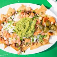 Nachos With Meat · Tortilla chips topped with beans, tomato, jalapeños, onions and guacamole.