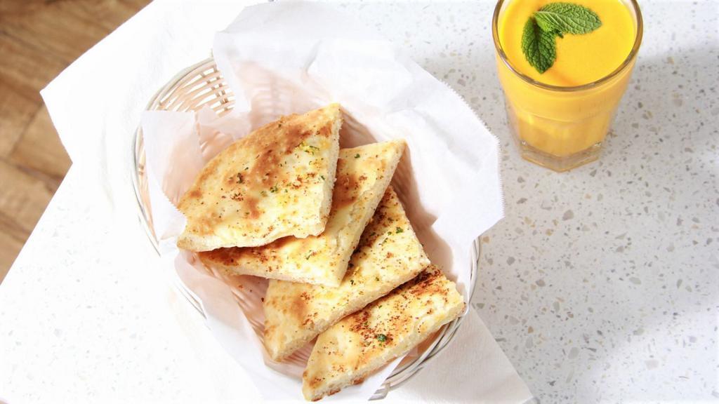 Garlic Naan · Leavened white bread with fresh garlic.